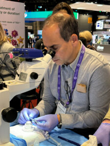 Dr William Tratter looking through a microscope
