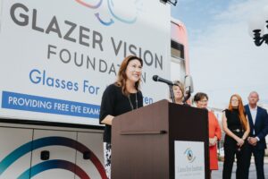 JL Speaking at a podium